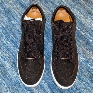 Woman’s Jimmy Choo black glitter sneaker
